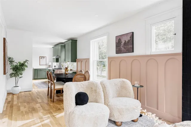 a living room with furniture a couch and a potted plant