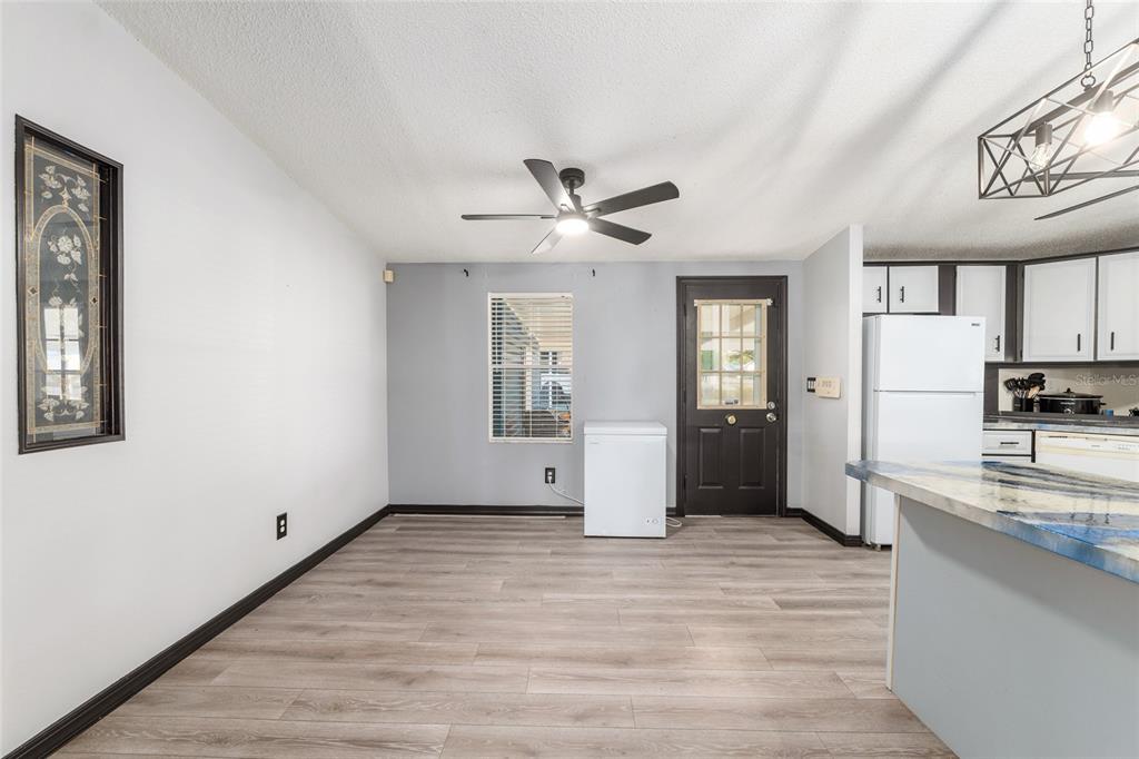 6832 Northeast 3rd Place Ocala, FL 34470 - Photo 14 of 70 a view of a kitchen with a sink and a refrigerator