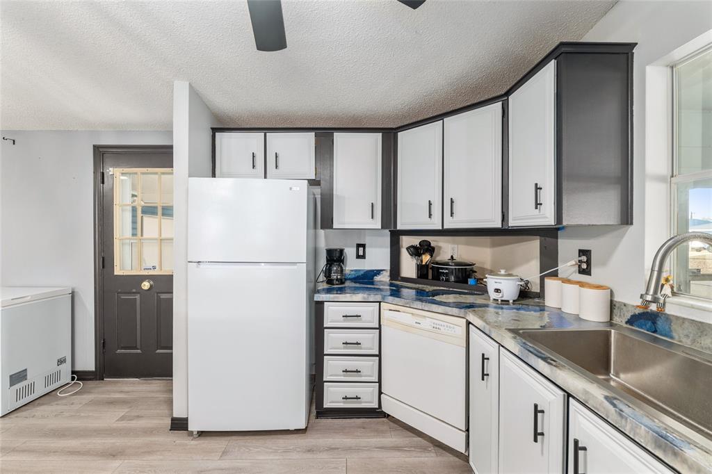 6832 Northeast 3rd Place Ocala, FL 34470 - Photo 21 of 70 a white refrigerator freezer sitting in a kitchen