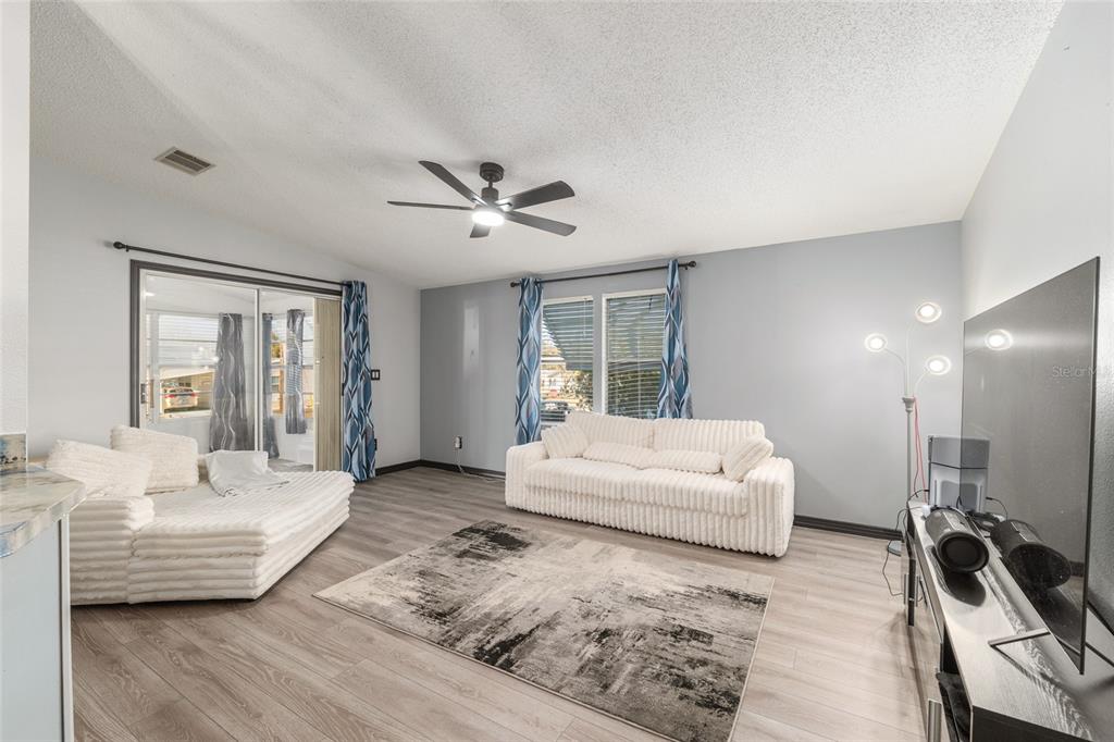 6832 Northeast 3rd Place Ocala, FL 34470 - Photo 22 of 70 a living room with furniture and a wooden floor