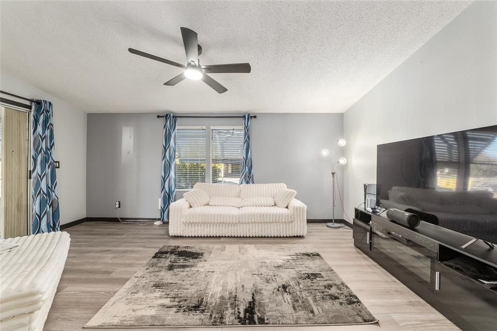 6832 Northeast 3rd Place Ocala, FL 34470 - Photo 23 of 70 a living room with furniture and a flat screen tv