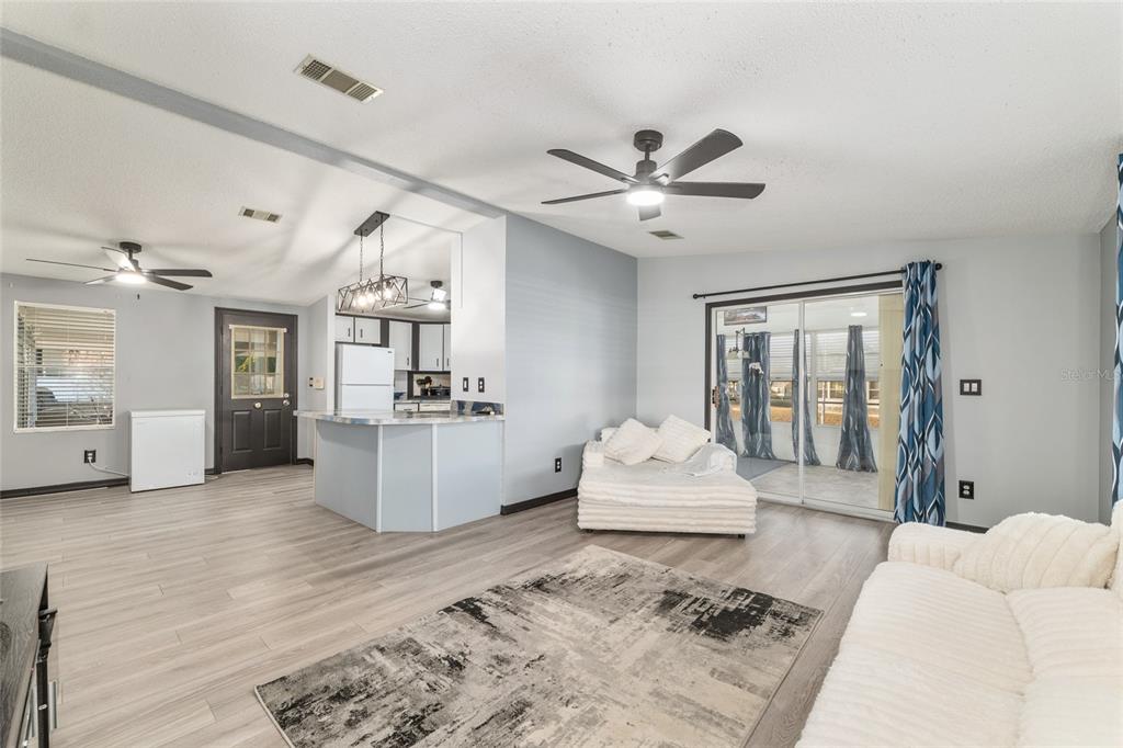 6832 Northeast 3rd Place Ocala, FL 34470 - Photo 24 of 70 a living room with furniture and a wooden floor