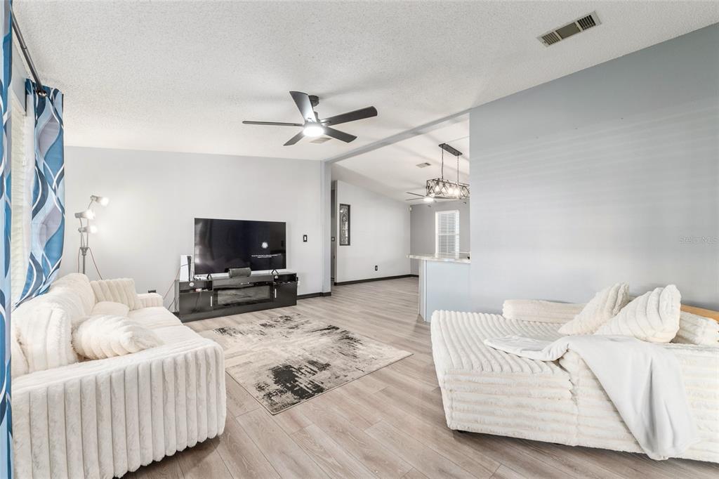 6832 Northeast 3rd Place Ocala, FL 34470 - Photo 25 of 70 a living room with furniture and a flat screen tv