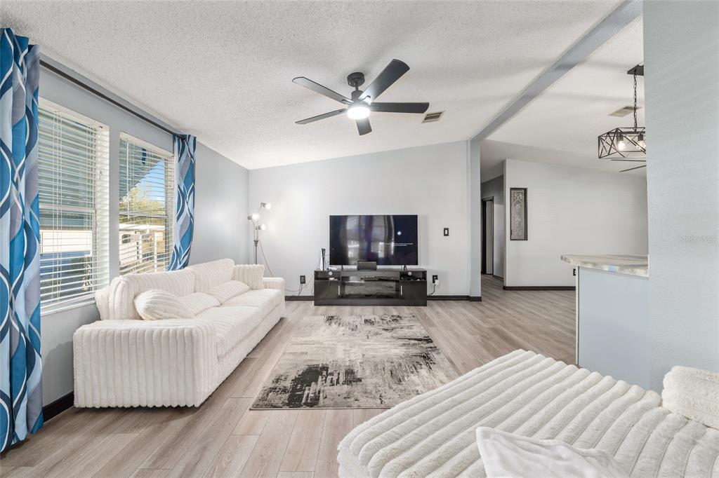 6832 Northeast 3rd Place Ocala, FL 34470 - Photo 26 of 70 a spacious bedroom with a bed and couch