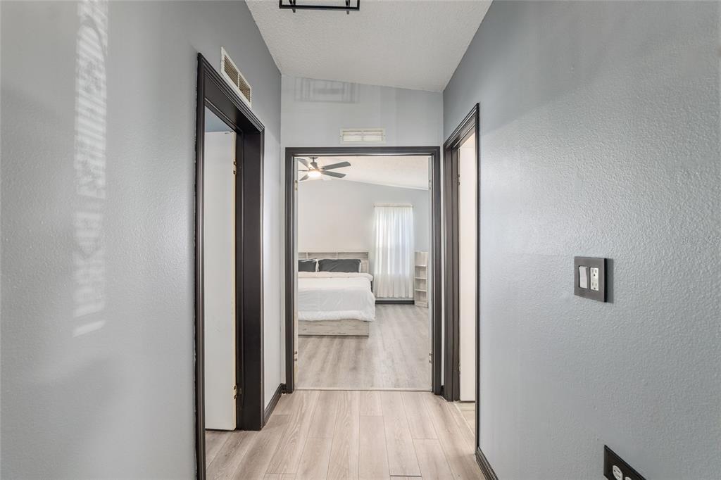 6832 Northeast 3rd Place Ocala, FL 34470 - Photo 27 of 70 a view of a bedroom from a hallway