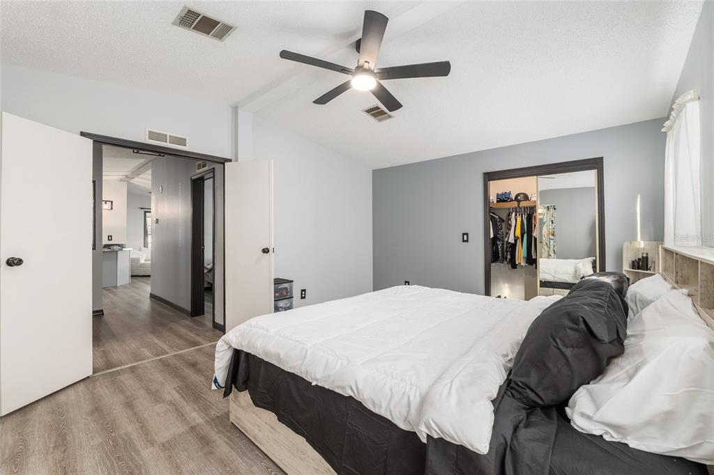 6832 Northeast 3rd Place Ocala, FL 34470 - Photo 30 of 70 a bed room with a bed and a ceiling fan