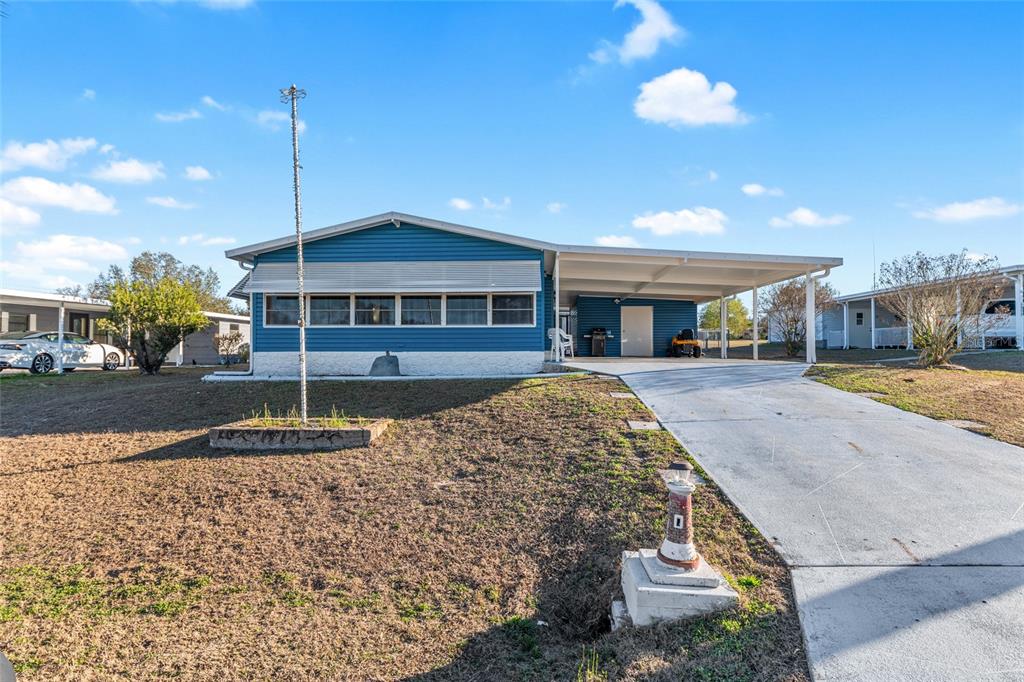 6832 Northeast 3rd Place Ocala, FL 34470 - Photo 3 of 70 a front view of a house with a yard