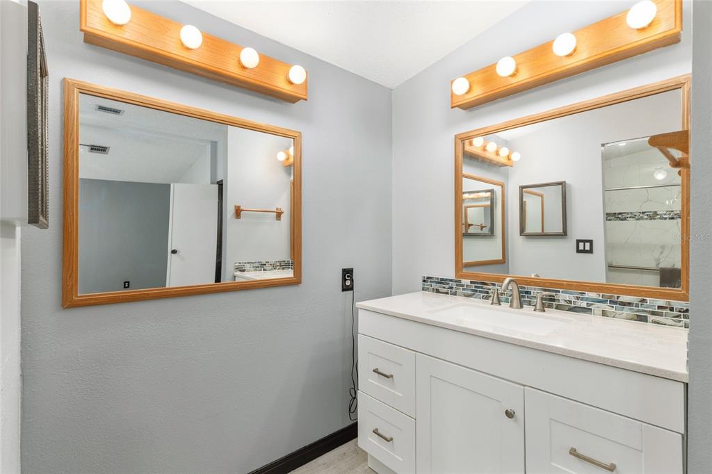 6832 Northeast 3rd Place Ocala, FL 34470 - Photo 32 of 70 a bathroom with a sink and a mirror