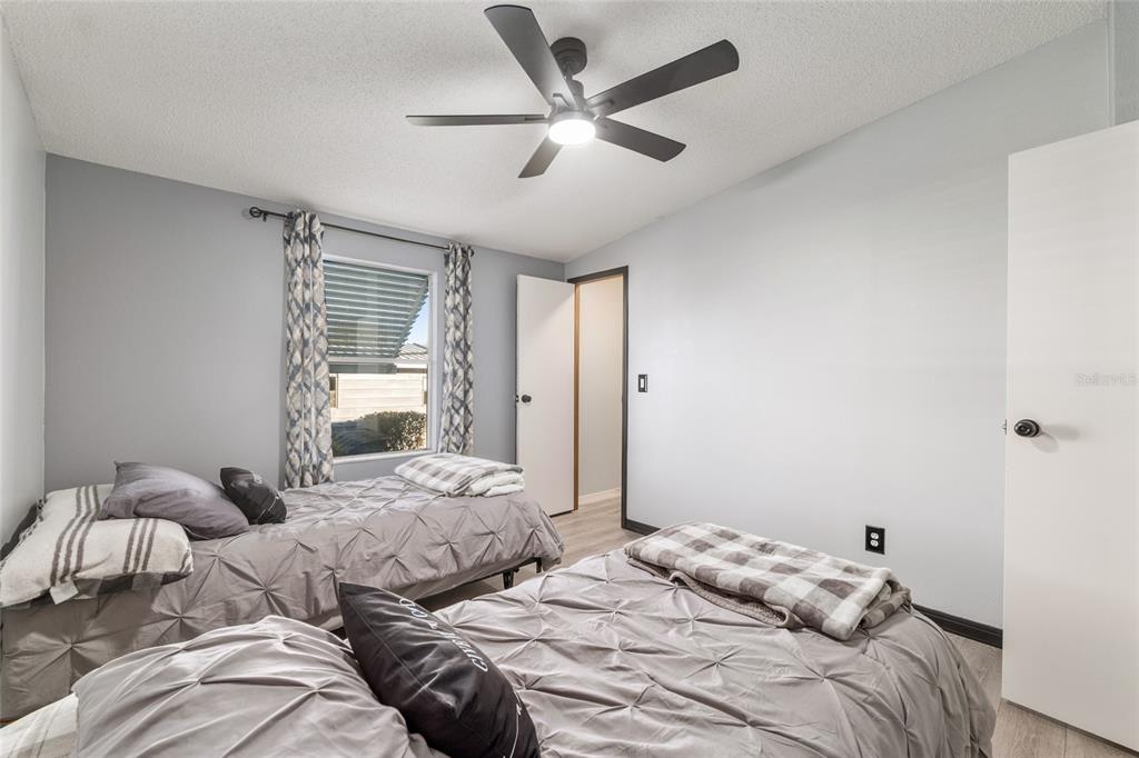 6832 Northeast 3rd Place Ocala, FL 34470 - Photo 37 of 70 a bedroom with two bed and a large window