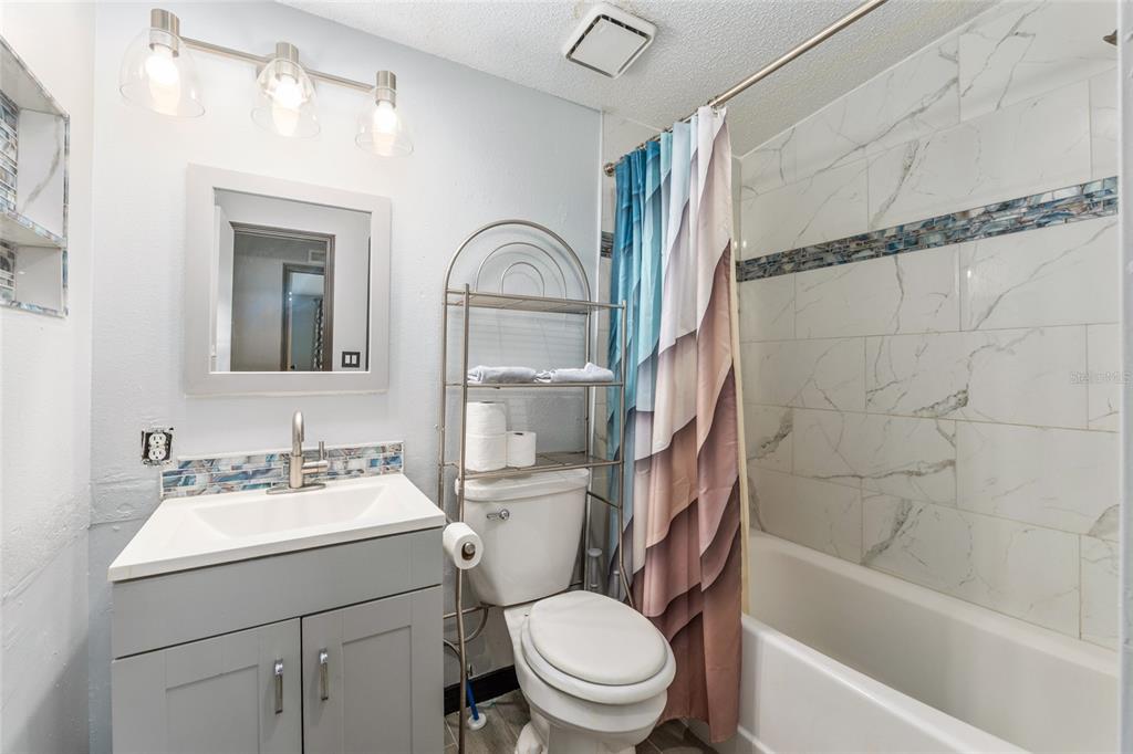 6832 Northeast 3rd Place Ocala, FL 34470 - Photo 40 of 70 a bathroom with a sink toilet and shower