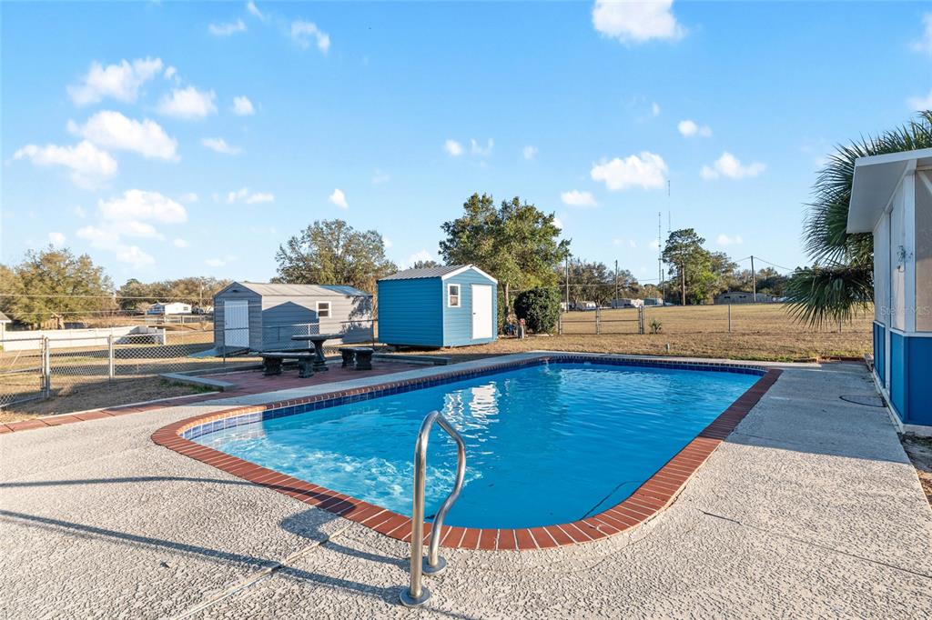 6832 Northeast 3rd Place Ocala, FL 34470 - Photo 48 of 70 a view of a swimming pool with a patio