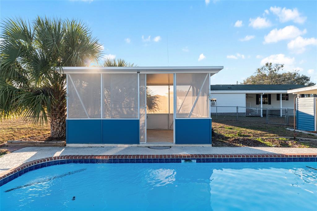 6832 Northeast 3rd Place Ocala, FL 34470 - Photo 56 of 70 a view of house with swimming pool and a yard