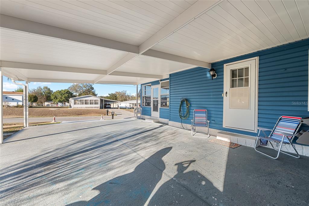 6832 Northeast 3rd Place Ocala, FL 34470 - Photo 8 of 70 a view of a patio with table and chairs with wooden floor and fence
