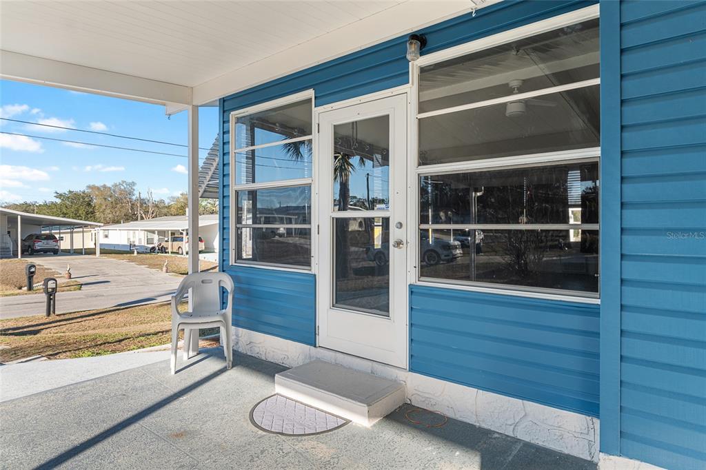 6832 Northeast 3rd Place Ocala, FL 34470 - Photo 10 of 70 a room with wooden floor and glass door