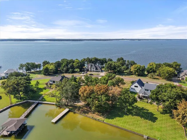 an aerial view of a houses with a lake view