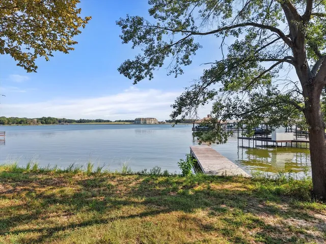 a view of a lake with houses in the back