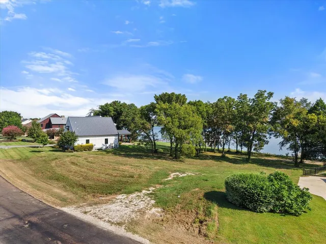 a backyard of a house with a yard and outdoor seating