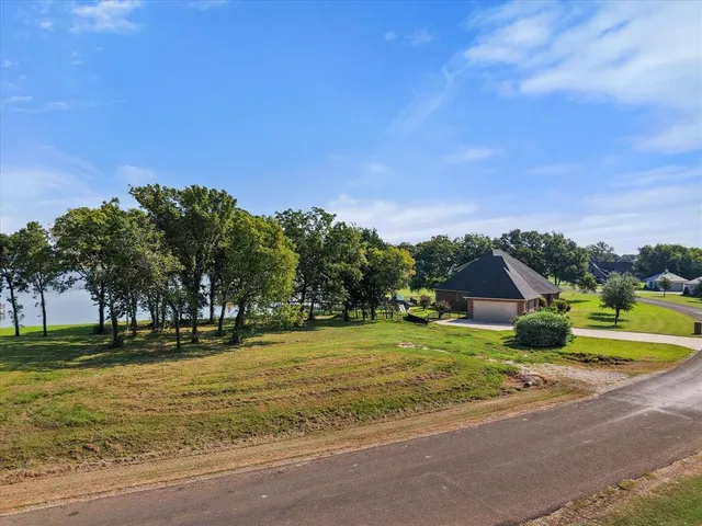 a view of a swimming pool with a yard and plants