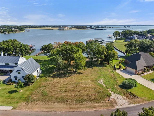a view of a lake with couches in the patio