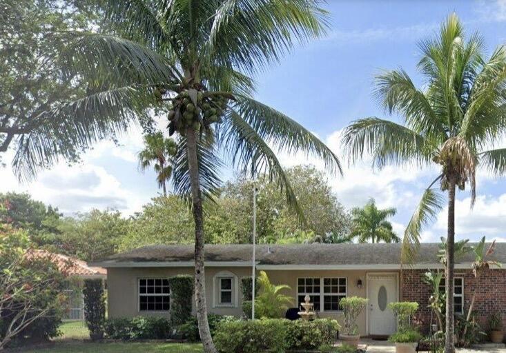 a view of house with palm trees