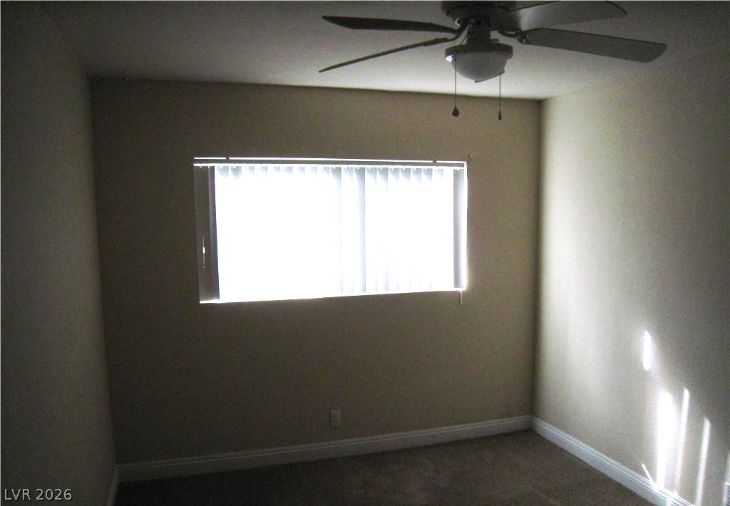 1844 North Decatur Boulevard, Unit 204 Las Vegas, NV 89108 - Photo 6 of 8 A well-lit bedroom features a ceiling fan, carpet flooring, and window blinds for comfort and privacy.