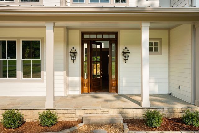 a living room with a fireplace and wooden floor