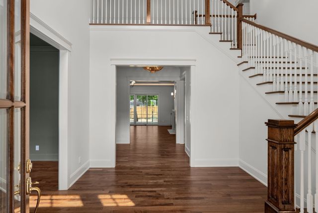 a view of a livingroom with wooden floor and a fireplace