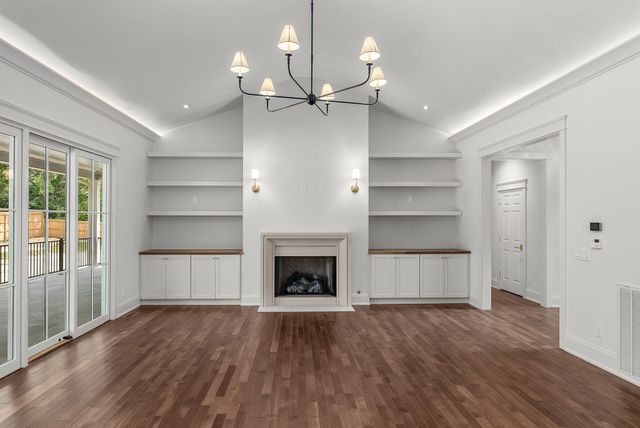 a kitchen with a refrigerator and chandelier