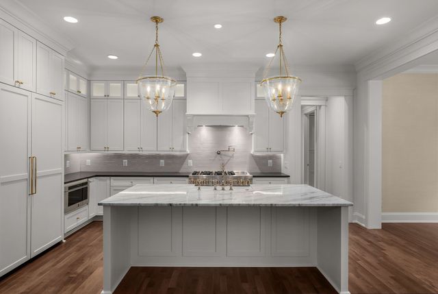 a kitchen with granite countertop a sink and a stove