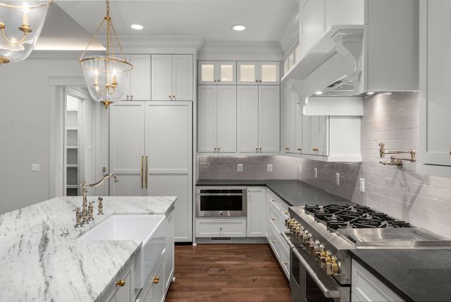 a bathroom with a granite countertop double vanity sink and vanity