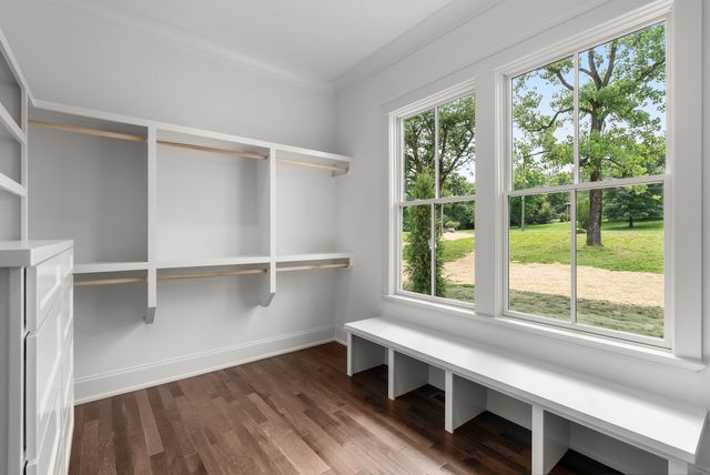 a kitchen with a sink chandelier and wooden floor