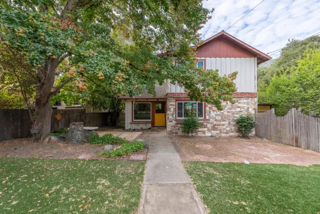 a front view of a house with a garden