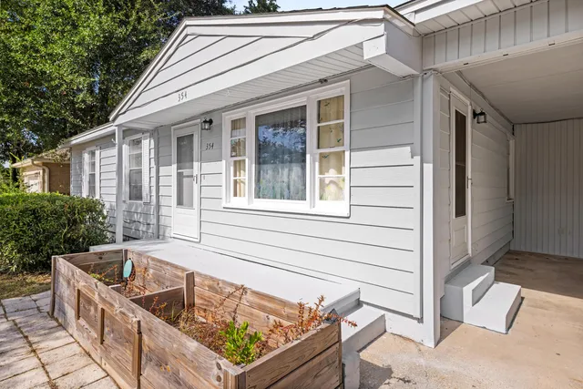 a view of house with backyard and seating space