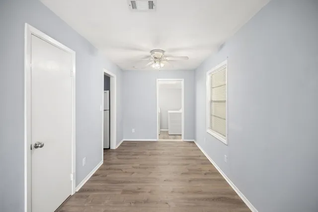 wooden floor in a room next to a window