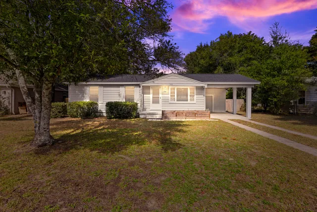 a view of house with a yard