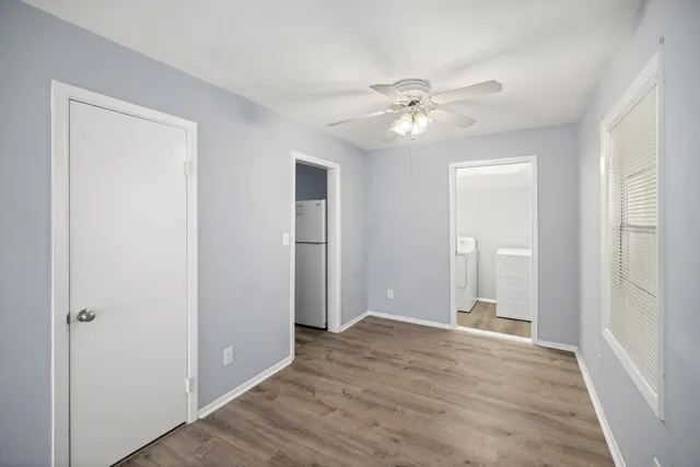 a view of an empty room with wooden floor