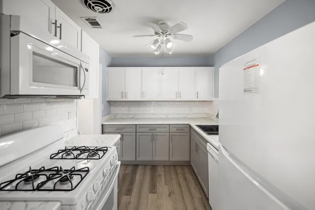 a kitchen with a stove a sink and a microwave