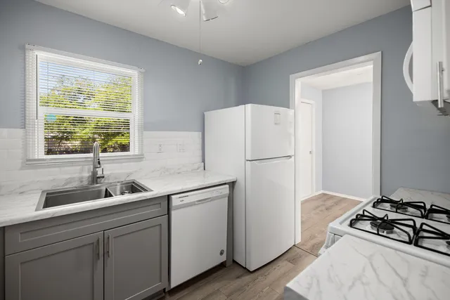a kitchen with a refrigerator and a sink