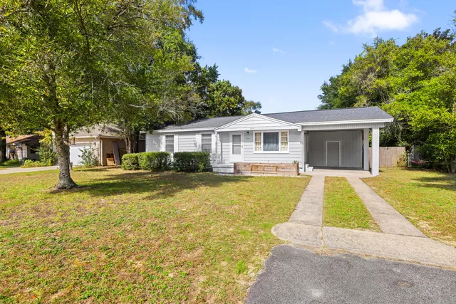 a front view of a house with a yard table and chairs