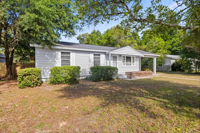 a front view of a house with a garden