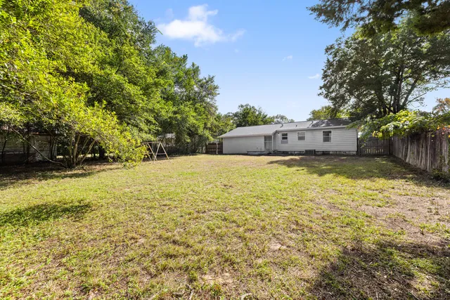 a view of a house with yard and sitting area