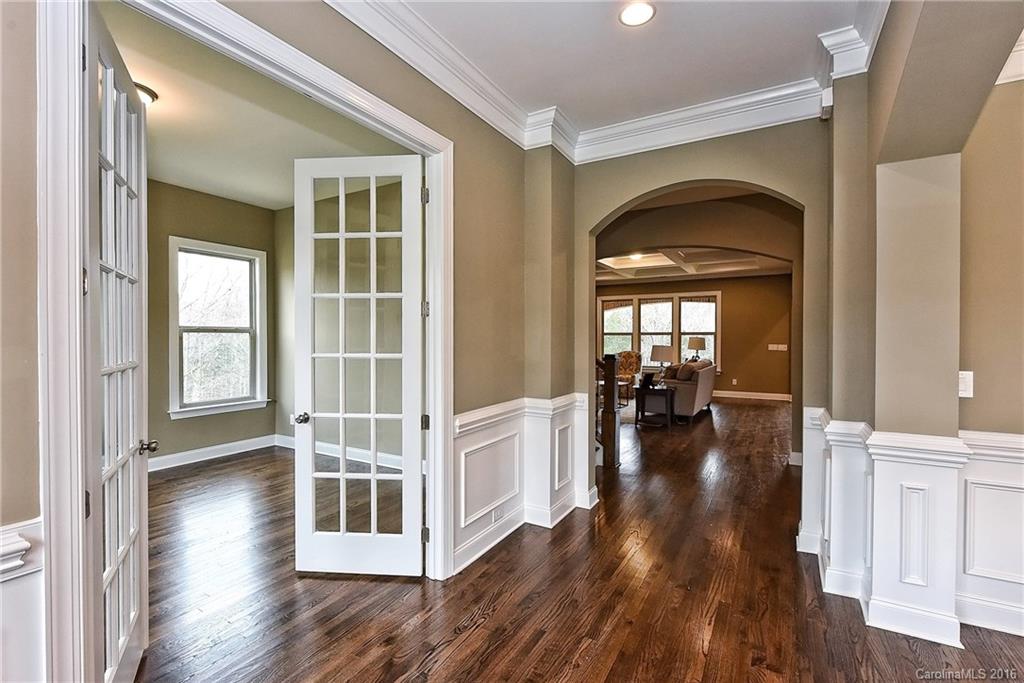 8069 Clems Branch Road Indian Land, SC 29707 - Photo 3 of 24 a view of a livingroom with wooden floor and white walls