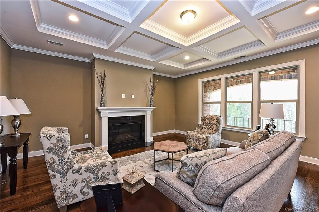 8069 Clems Branch Road Indian Land, SC 29707 - Photo 8 of 24 a living room with furniture a fireplace and a large window