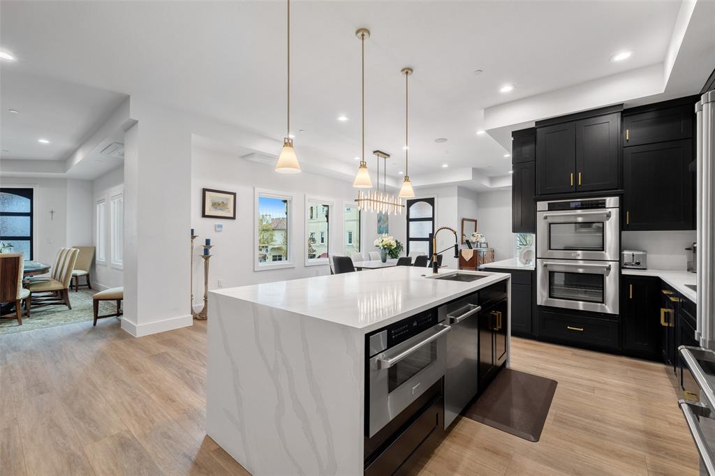 62 Main Street, Unit 200 Colleyville, TX 76034 - Photo 11 of 37 a kitchen with stainless steel appliances kitchen island a large island in the center