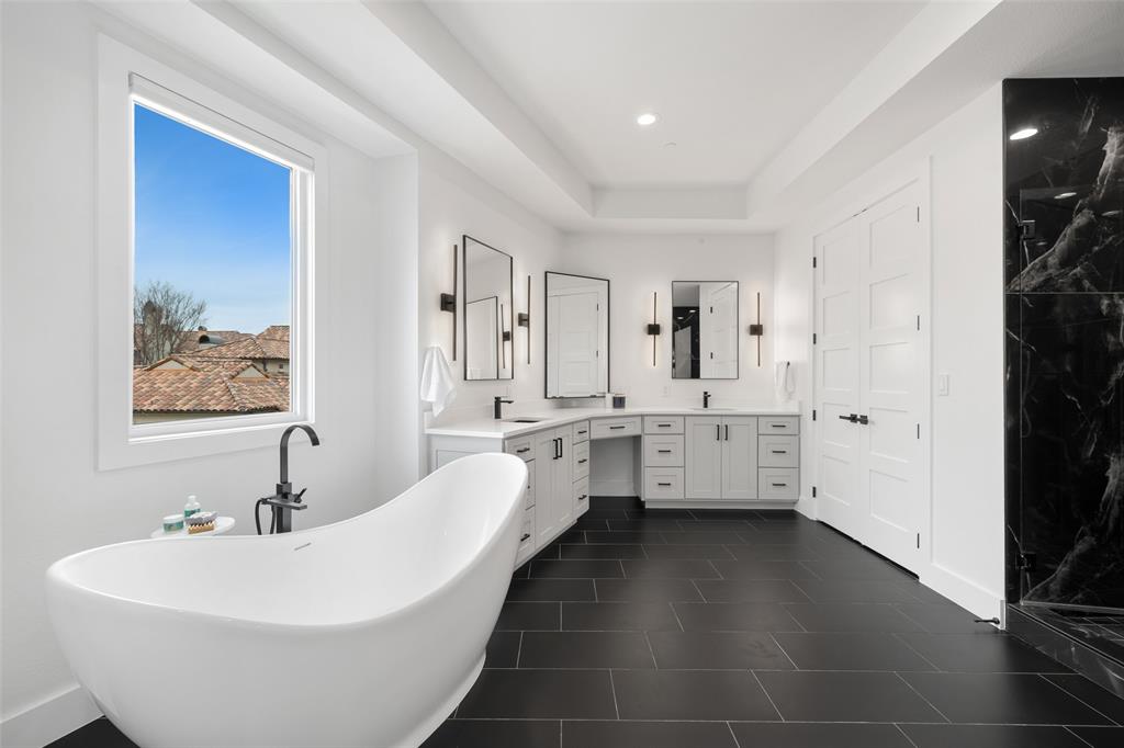 62 Main Street, Unit 200 Colleyville, TX 76034 - Photo 21 of 37 a bathroom with double vanity sinks a mirror and a bathtub