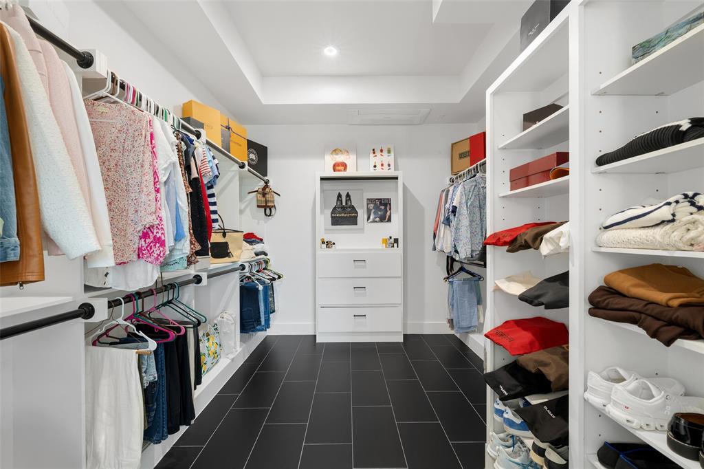 62 Main Street, Unit 200 Colleyville, TX 76034 - Photo 24 of 37 a view of walk in closet with clothes shoes and a rug