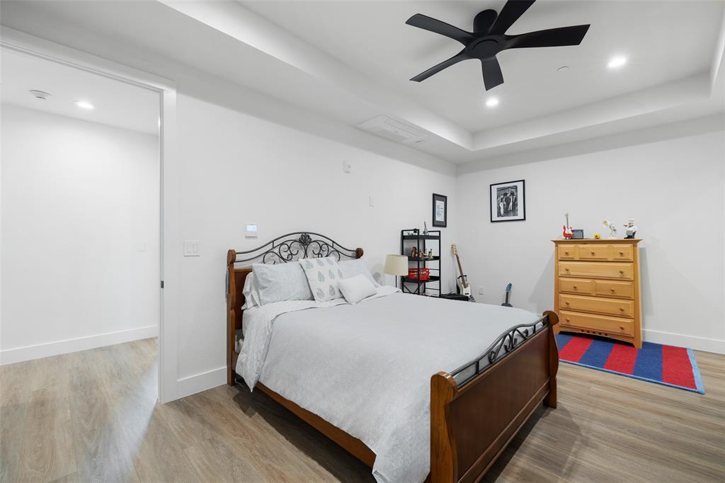 62 Main Street, Unit 200 Colleyville, TX 76034 - Photo 26 of 37 a bedroom with a bed and a chandelier