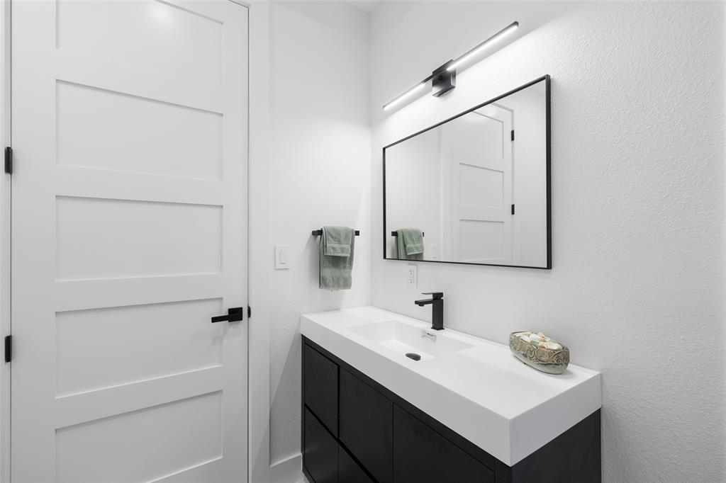 62 Main Street, Unit 200 Colleyville, TX 76034 - Photo 30 of 37 a bathroom with a sink a mirror and a shower