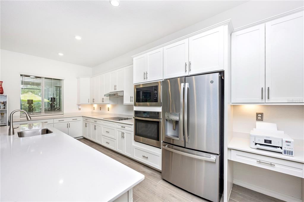 12845 Tulum Loop Venice, FL 34293 - Photo 12 of 100 a kitchen with stainless steel appliances a refrigerator sink and microwave