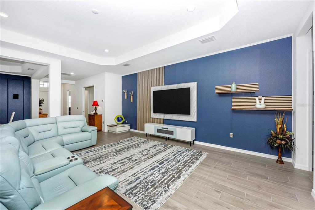 12845 Tulum Loop Venice, FL 34293 - Photo 19 of 100 a living room with furniture and a flat screen tv